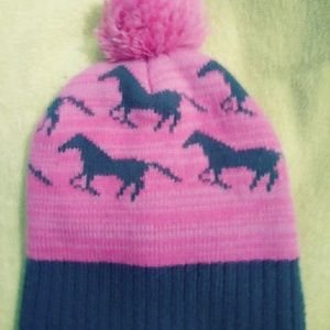 An Ash Rose hat with gray horses running circles